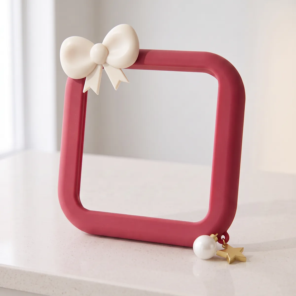 Holly Bow: a cranberry silicone frame with an ivory bow